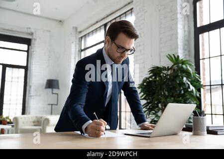 Focused young businessman doing online research analysis. Stock Photo