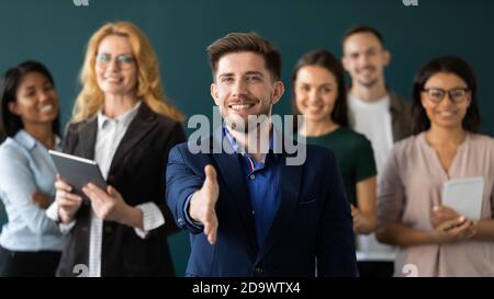 Positive confident male hr extending hand greeting new staff member Stock Photo