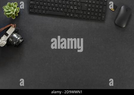 Directly above of computer parts with camera by green plant on table Stock Photo