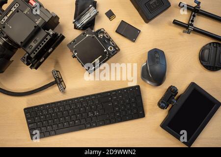 Flat lay of filming accessories with computer parts on table Stock Photo