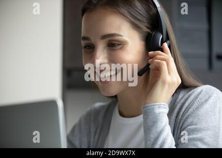 Pleasant young woman consultant assisting client online giving recommendation Stock Photo