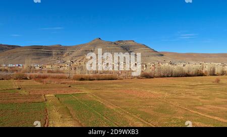 Panorama view of small Berber village with loam buildings near Imilchil, Morocco, Africa in the Atlas Mountains with green colored fields. Stock Photo