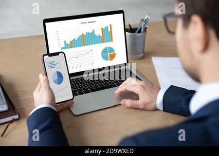 Focused young male ceo executive manager using modern technology gadgets. Stock Photo