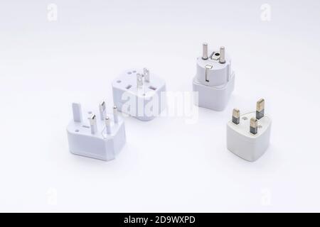 Group of universal plugs adapters isolated on white background. Stock Photo