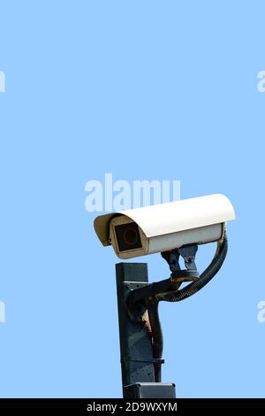 Security cameras (CCTV) or surveillance camera on pole isolated on blue background. Stock Photo