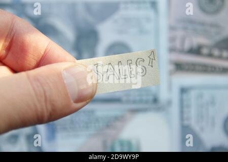 Sales growth idea. Label with an inscription and dollar banknotes. Stock Photo