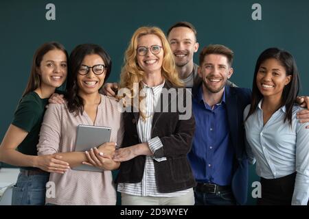 Group portrait of happy ambitious motivated multiethnic team standing together Stock Photo