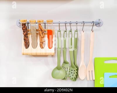 Modern design of the kitchen tools hanging on wall in the kitchen room. Stock Photo
