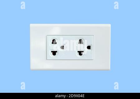 AC power plug isolated on blue background. Stock Photo