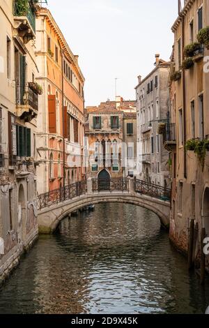 One of the countless beautiful small canals in the old town of Venice, Italy Stock Photo