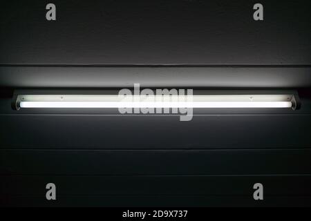 Closeup of the fluorescent on concrete ceiling. Stock Photo