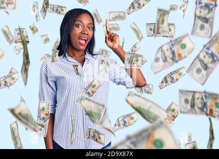 Young african american woman wearing casual clothes pointing finger up with successful idea. exited and happy. number one. Stock Photo