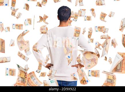 Young african amercian man wearing casual clothes standing backwards looking away with arms on body Stock Photo