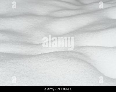 Wavy snow surface background, bumpy land covered by newly-fallen snow, shallow depth of field Stock Photo