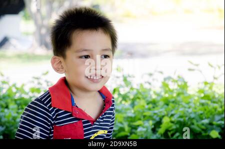 Closeup of the face of Asian boy smiling happily. Stock Photo