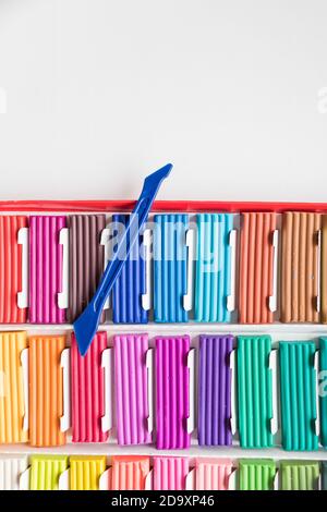 Rainbow colors plasticine box isolated on white background.Colorful kid's plasticine, dough modeling clay.Set of Soft colored wax clay.Copy space Stock Photo