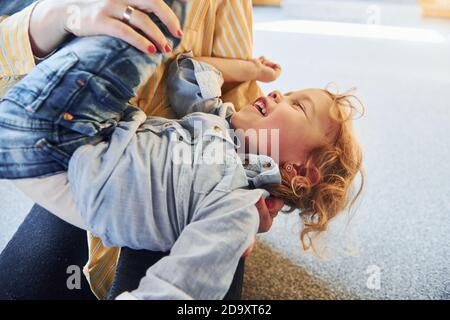 Child in jeans and casual clothes have fun indoors Stock Photo