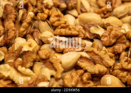 Pistachios and walnuts lie on the sacking. Close up Stock Photo