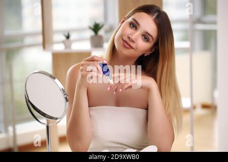 Beautiful woman applying make-up in beauty concept Stock Photo