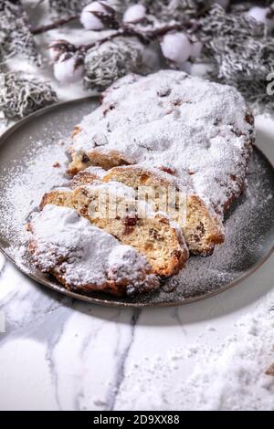 Christmas baking stollen cake with xmas decorations over white marble Stock Photo