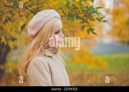 Beautiful woman on yellow autumn leaves background Stock Photo