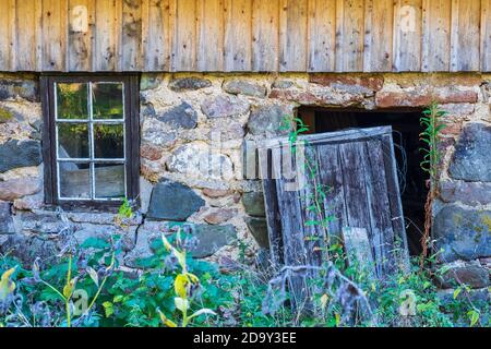 Abandoned house with a wild garden Stock Photo