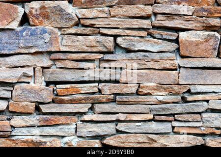 Part of a sandstone stone wall, expressive texture and background. Stock Photo