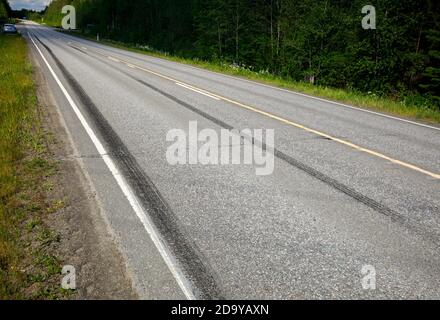 Very long skid marks on tarmac surface at highway after hard braking  at Summer , Finland Stock Photo