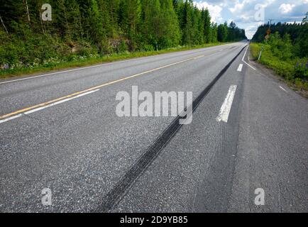Very long skid marks on tarmac surface at highway after emergency braking at Summer , Finland Stock Photo