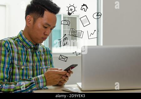 businessmen look at information on smart phones to find ideas for growing business at desk.Business Concept and icons. Stock Photo