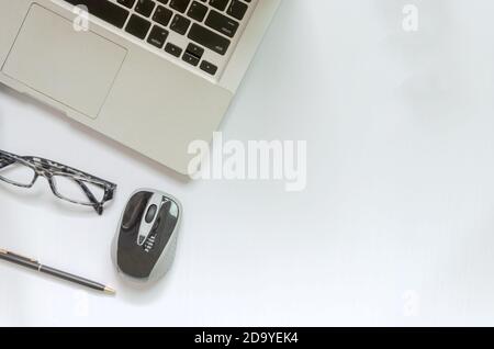 Top view Computer, pen, mouse and glasses on white background. copy space Stock Photo