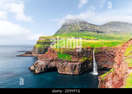 Incredible autumn view of Mulafossur waterfall in Gasadalur village, Vagar Island of the Faroe Islands, Denmark. Landscape photography Stock Photo