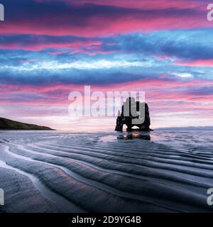 Basalt stack Hvitserkur on the Vatnsnes peninsula, Iceland, Europe in low tide time. Great purple sky glowing on background. Landscape photography Stock Photo