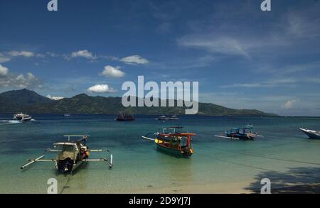 Boats tied up in the shallow seas of the Gili islands, Indonesia Stock Photo