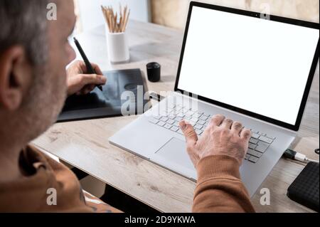 businessman analyzing statistics on laptop screen, working with financial graphs charts online, using business software for data analysis and project Stock Photo