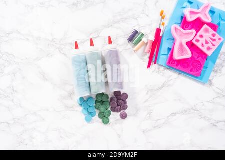 Flat lay. Ingredients to make chocolate mermaid molds from the chocolate chips. Stock Photo