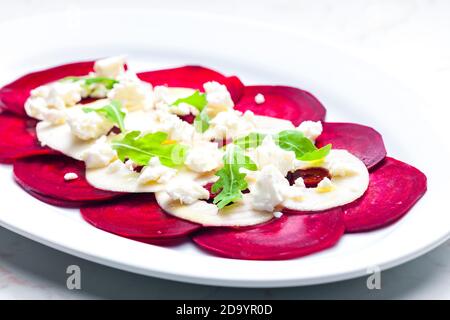 fresh beetroot and apple salad with fresh goat cheese and arugula Stock Photo
