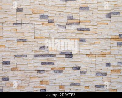 Wall with decorative stonework. Background texture. Full screen Stock Photo