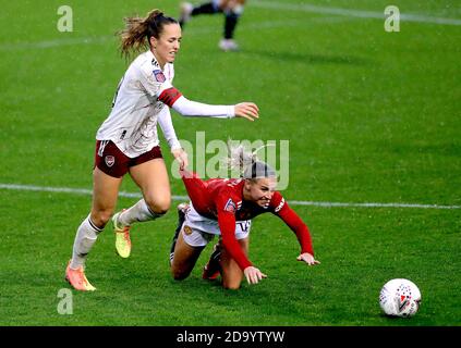 Arsenal's Lia Joelle Walti (left) and Manchester United's Jackie Groenen battle for the ball during the FA Women's Super League match at Leigh Sports Village. Stock Photo