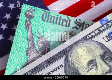 One Hundred Dollar Bill with Tax Retrun Check and American Flag. Stock Photo