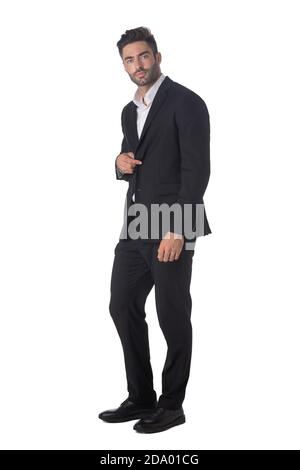 Full length portrait of young handsome business man in black suit studio isolated on white background Stock Photo