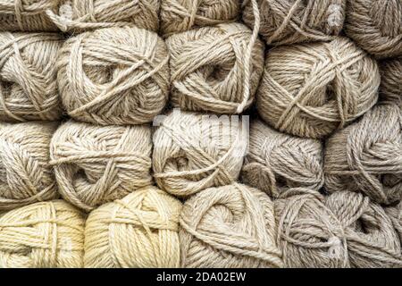 Background from tangles wool yarn, beige threads from natural wool. Stock Photo