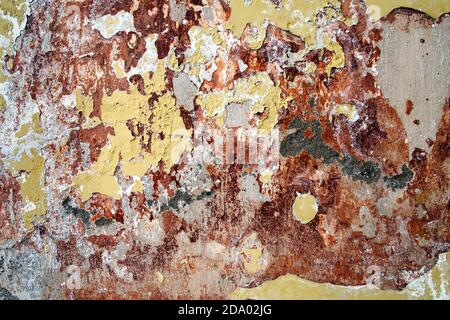 old painted cracked of cement background with yellow paint and red stains Stock Photo