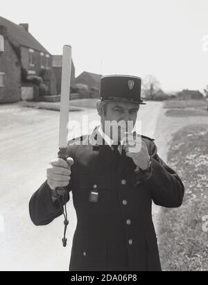 1980s, historical, a man dressed up as a french policeman blowing
