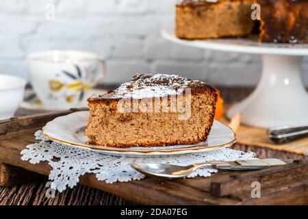 Spiced orange and almond cake dusted with icing sugar and drizzled with honey Stock Photo