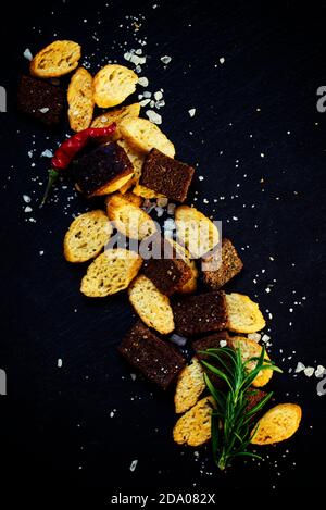 Unhealthy food concept, spicy salted crackers, dark background top view Stock Photo