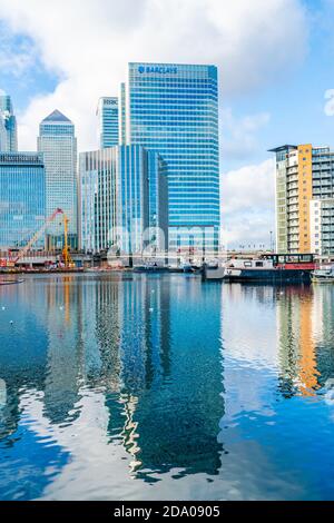LONDON, UK - NOVEMBER 03, 2020: Modern skyscrapers of Canary Wharf, the financial hub in London seen across Blackwall Basin Stock Photo