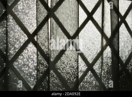 Background of leaded light glass window with see through curtain Stock Photo