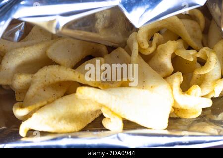 Potato chips close up look inside a snack aluminiup packet Stock Photo