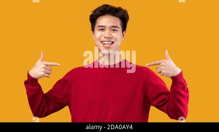 Happy asian man pointing fingers at himself Stock Photo